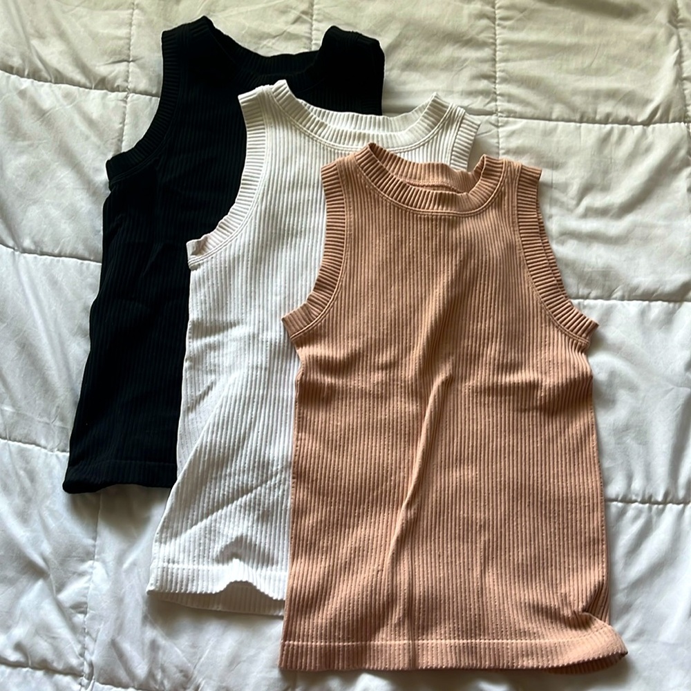 Black, white, and pink sleeveless tops.